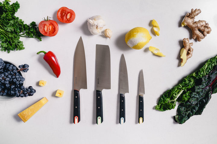 The four Macrum knives side by side with produce: Burnside Chef, St. Johns Vegetable, Fremont Utility and Tilikum Paring